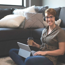 CDU student Ally working at home on her lounge floor