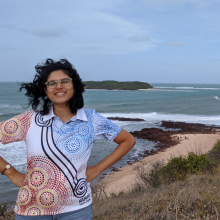 Harita smiling in front of a view of the ocean