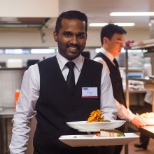 Student in training with a plate of food at Karawa Training Restaurant in Palmerston 