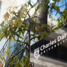 Charles Darwin University sign surrounded by leaves