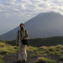 Tom Duncan with hill and clouds in background