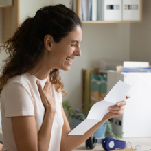 Women receiving an approved application and smiling