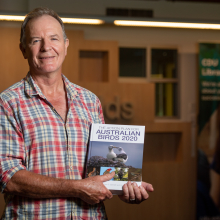 CDU Conservation Professor Stephen Garnett with the Action Plan for Australian Birds 2020 book he edited that identified 216 threatened birds in Australia.