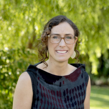 Dr Gianna Bonis-Profumo head and shoulders with green leafy background