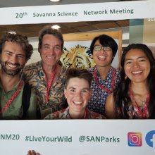 five grinning people in a frame saying 20th savanna science network meeting