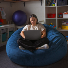 Occupational therapy student Dom studying on a beanbag