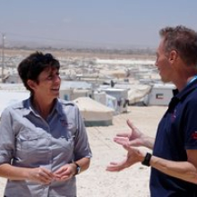 Emma Kettle with RedR Australia electrical engineer John Simpson in front of a section of Za’atari refugee camp