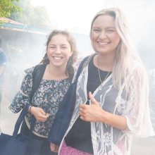 New CDU Psychology students Emmy Lang and Jacquelyn Agustin enjoy a traditional smoking ceremony as part of the university’s Semester 2 Orientation activities