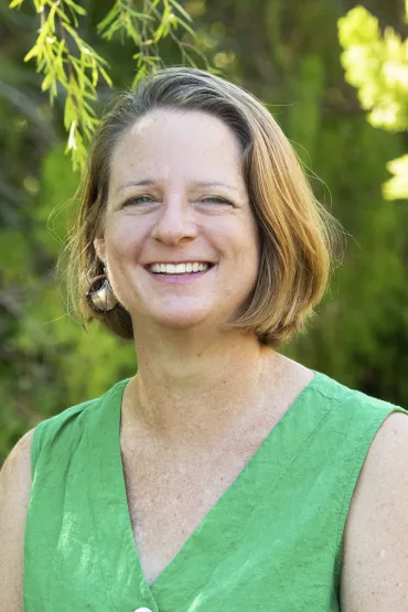 Pia Harkness head and shoulders with vegetation in the background