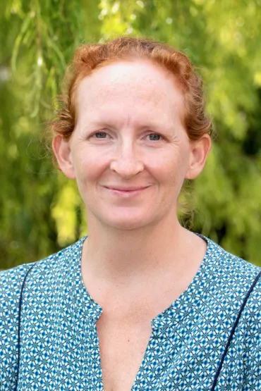 Dr Emily Gibson head and shoulders with green leafy background