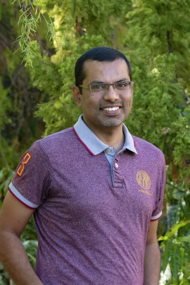 Dr Salman Quddus with background of green leafy vegetation