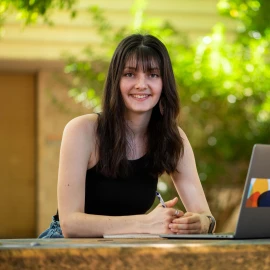Nursing student on campus with laptop
